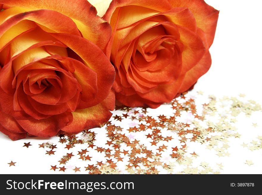Two red roses and stars isolated over white background