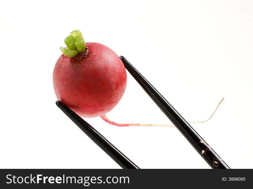 Fresh Radish held with black inlaid chopsticks. Fresh Radish held with black inlaid chopsticks