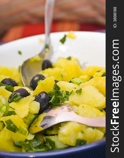 Bowl of mixed green vegetables on a table, with other food on the perimeter.