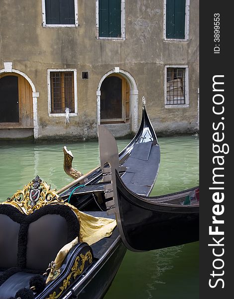 Two venecian gondolas in canal on the background of old ncient houses