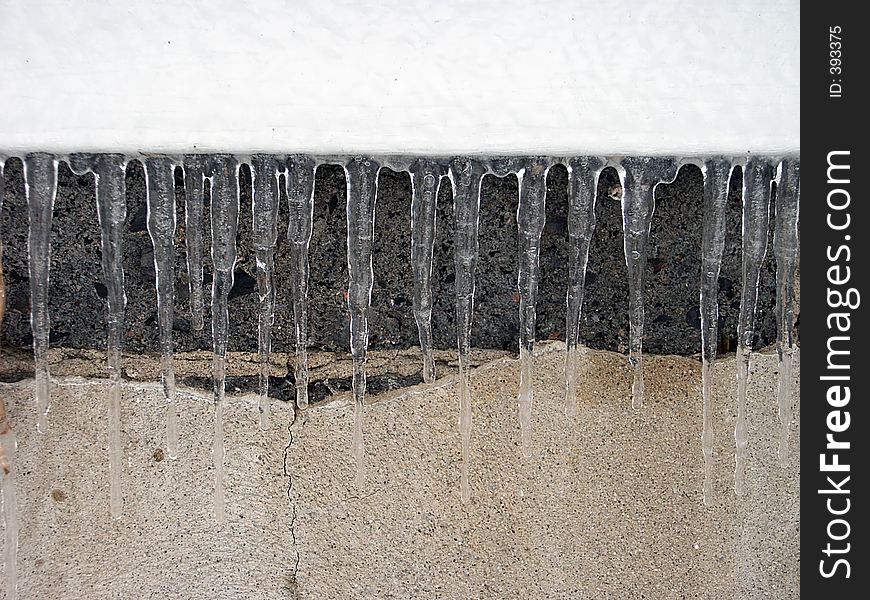 Icicles hanging on the side of a house