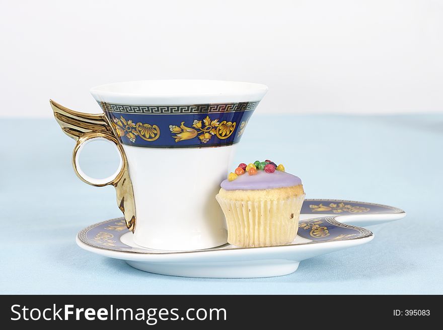 Teacup and cake on a table - landscape version. Teacup and cake on a table - landscape version