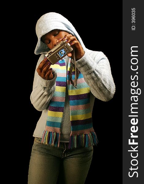 A teenage girl taking a self portrait. Isolated on a black background. A teenage girl taking a self portrait. Isolated on a black background.