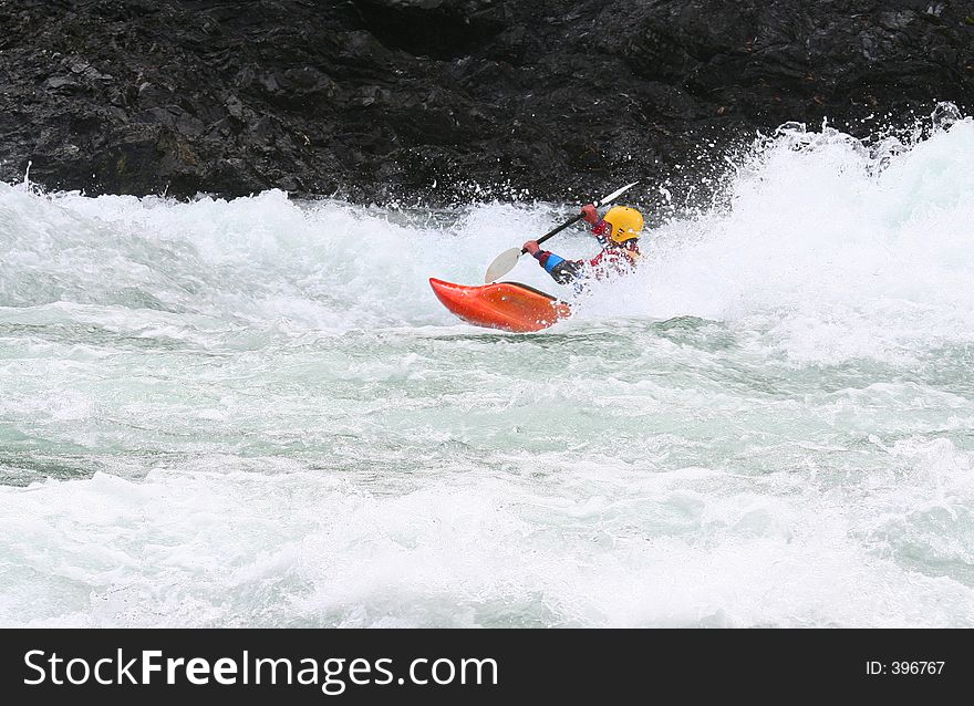 A kayaker braking the waves