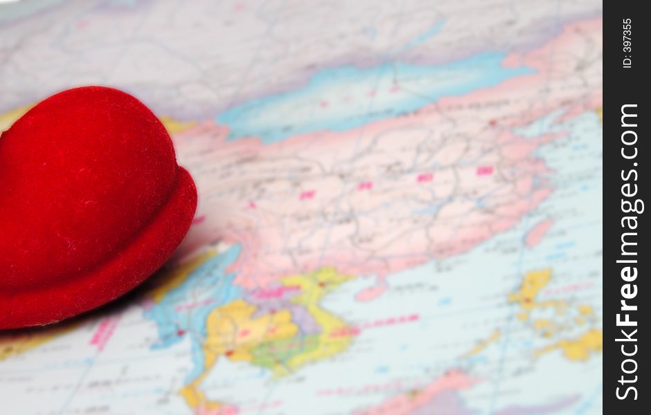 Santa's red boot tip on a world map.The boot is in focus and the map is blurry,out of focus. Santa's red boot tip on a world map.The boot is in focus and the map is blurry,out of focus.