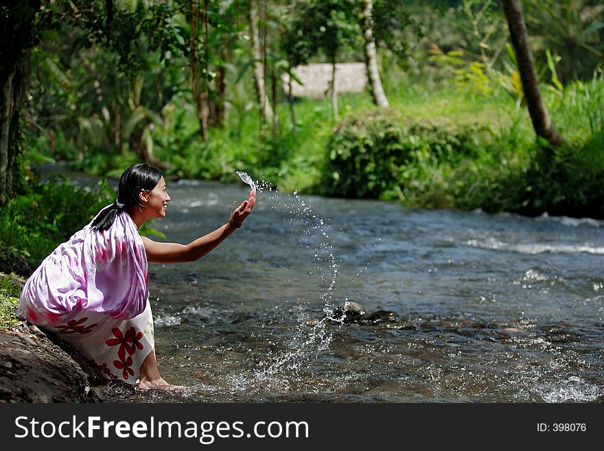 Attractive Asian woman playing with water. Attractive Asian woman playing with water.