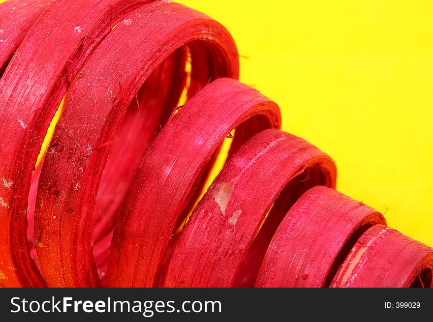 Curled Red Wood on a Yellow Background. Curled Red Wood on a Yellow Background