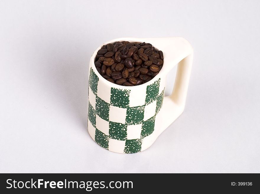 A cup full of coffee beans. A cup full of coffee beans