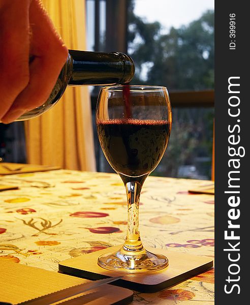 Wine being poured into a glass. Wine being poured into a glass