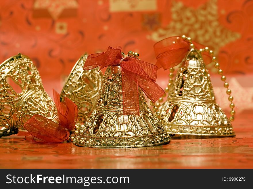 Golden Christmas bells with red ribbon
