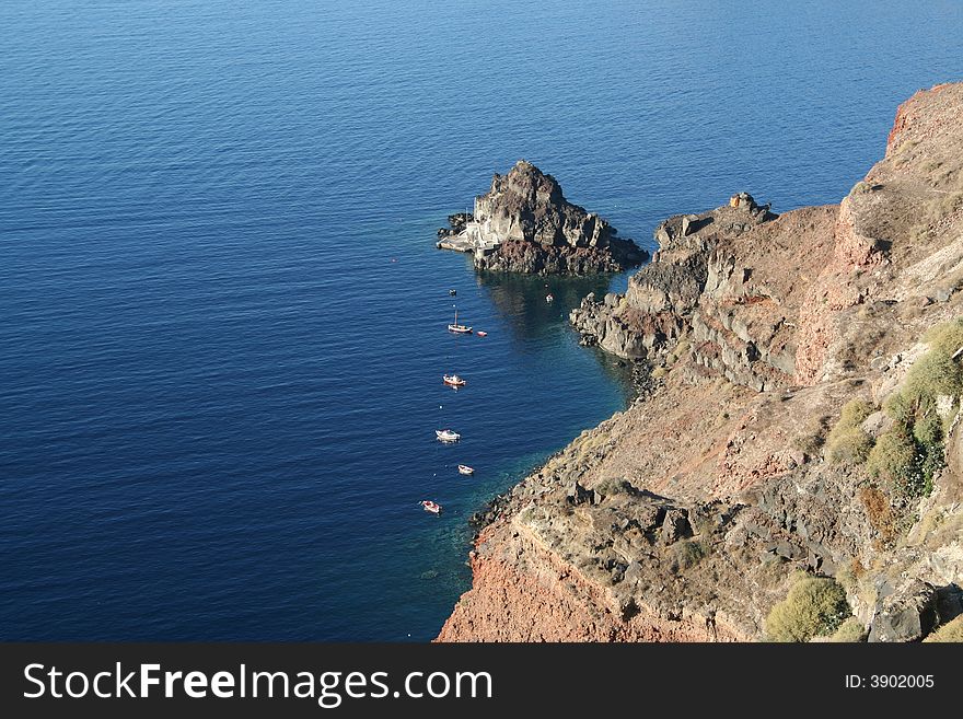 Rocks on the blue water. Rocks on the blue water