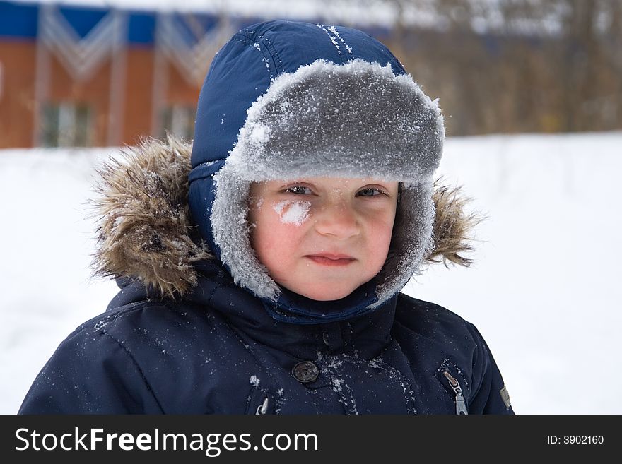 Offended little boy on a background of a snow. Offended little boy on a background of a snow