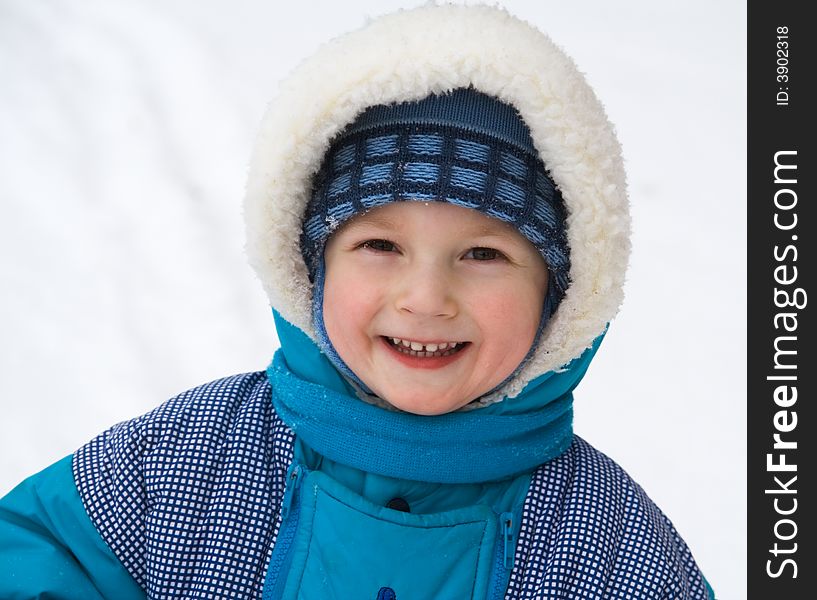 Cheerful boy on a background of a snow. Cheerful boy on a background of a snow