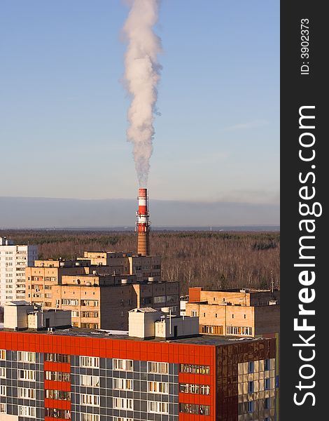 Stand-alone red-white boiler-house chimney smoking. Stand-alone red-white boiler-house chimney smoking