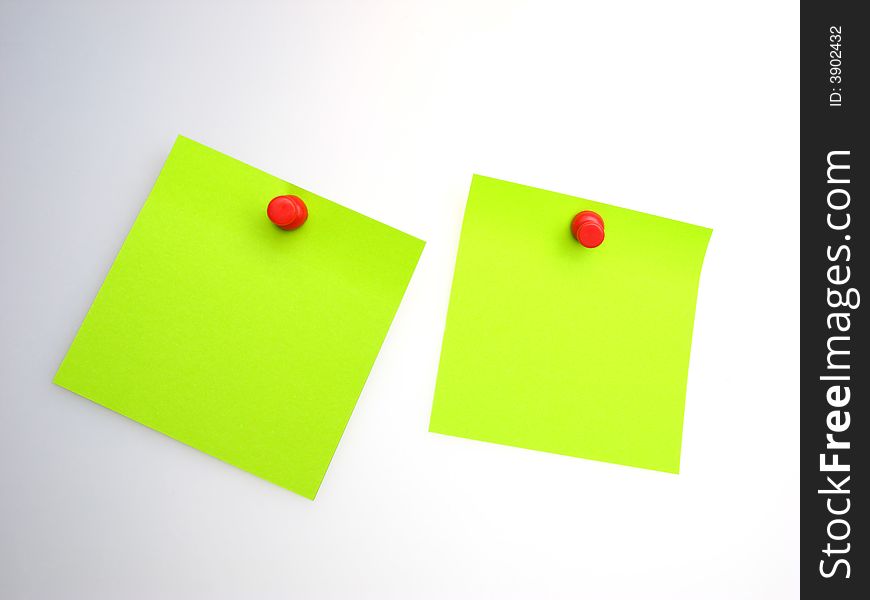 Two sheet of  green paper and  red writing button on  light background