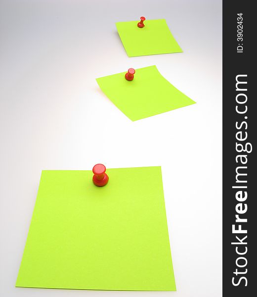 Three sheet of  green paper and  red writing button on  light background