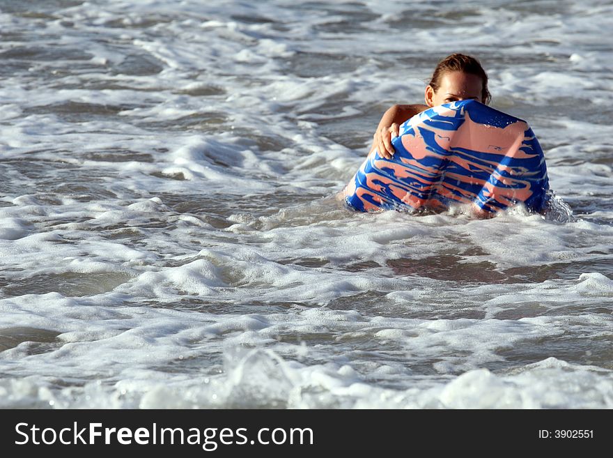 Bikini girl surfing on boogie board