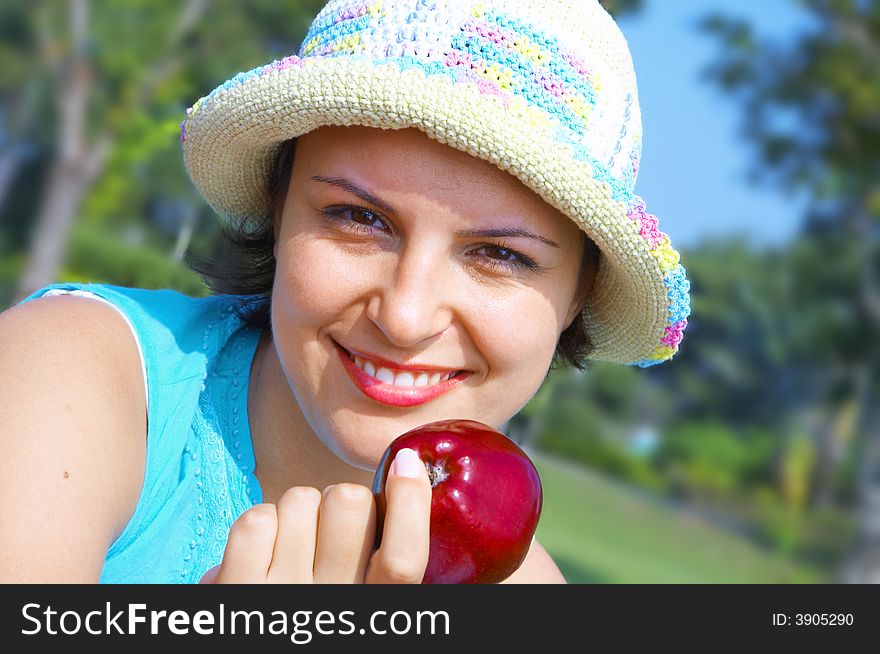 Portrait of young beautiful woman in colorful hat in summer environment. Portrait of young beautiful woman in colorful hat in summer environment