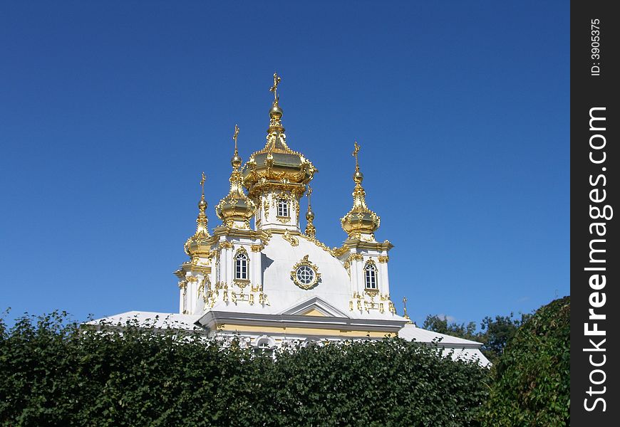 Snow-white church with gold cupola