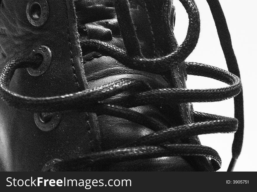 Black leather boot with laces on white back ground. Black leather boot with laces on white back ground