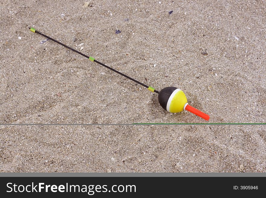 Fishing float in the sand