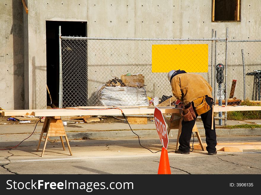 Carpenter cutting a beam.