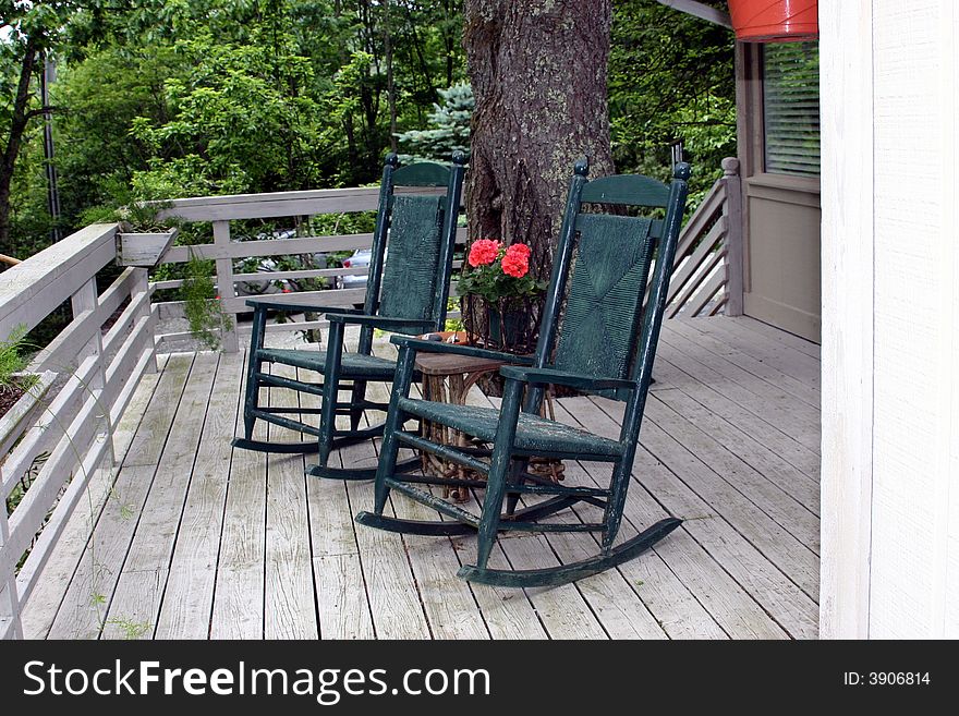 Two lonely rockers on deck of home in the mountains. Two lonely rockers on deck of home in the mountains.