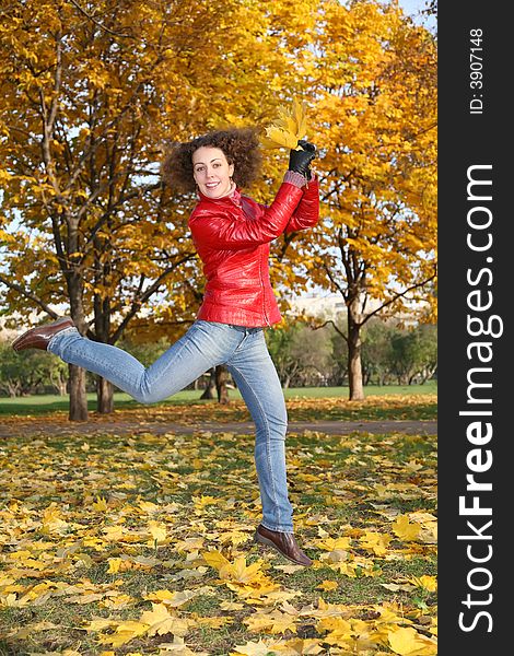 Girl in red jacket jumps in park