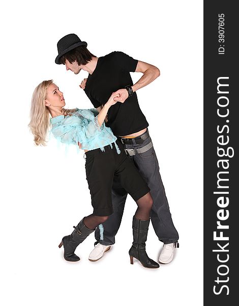 Girl in cyan blouse dances with boy in black hat on white