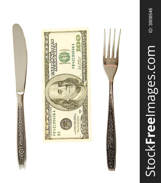 One hundret dollars lying between fork and knife. One hundret dollars lying between fork and knife