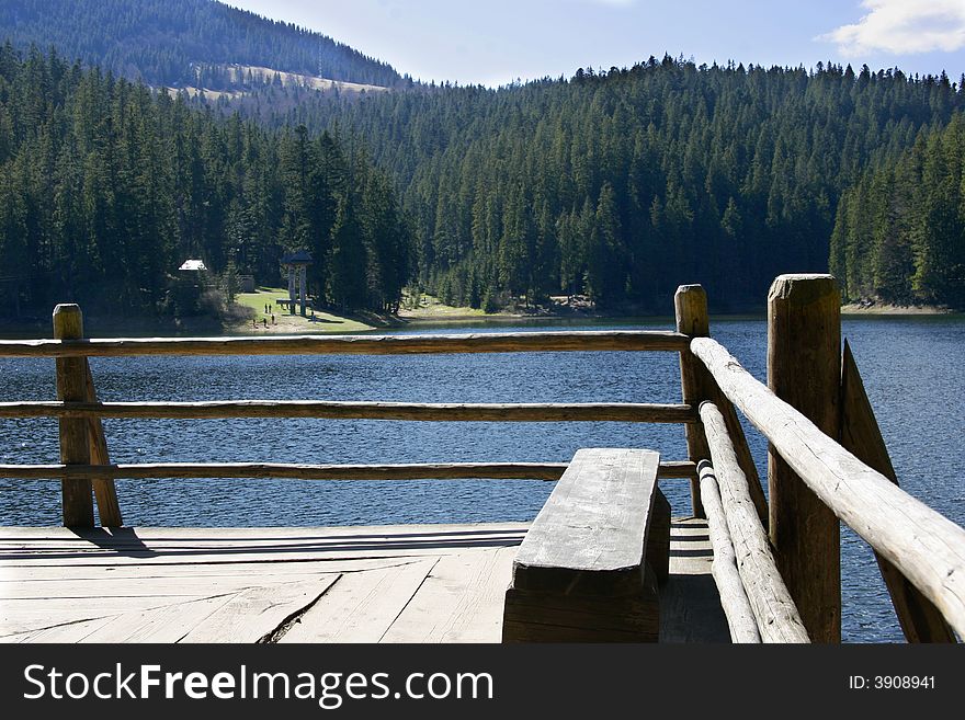 Wooden bench on lake shore