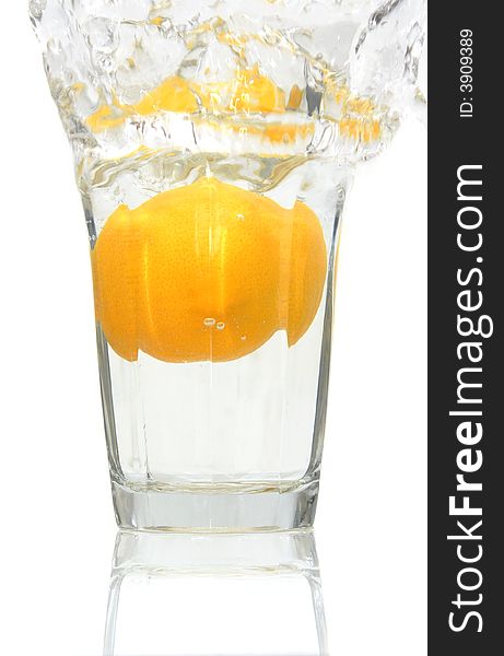 Lemon falling into a glass of ice cold water. Lemon falling into a glass of ice cold water