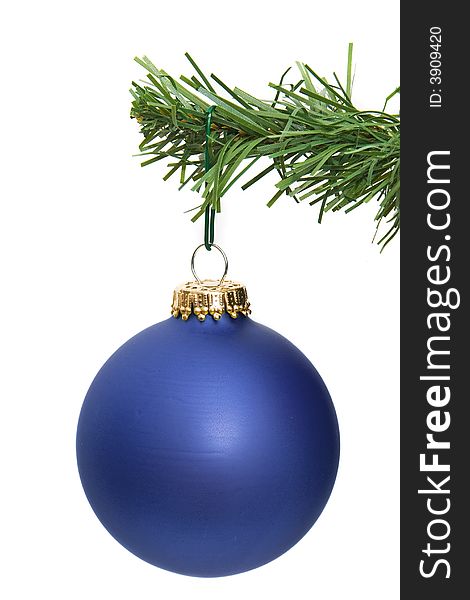 Blue ornament hanging on a pine tree branch