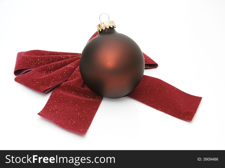 Red bow and an ornament isolated against white background