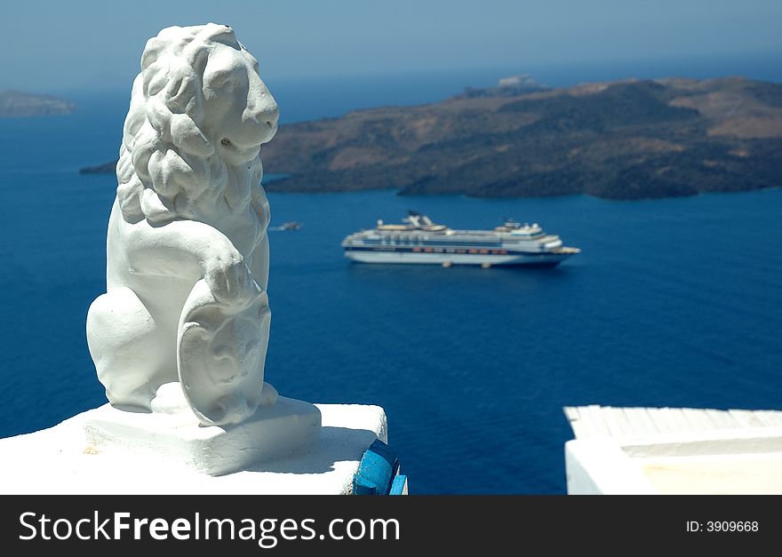 Statue and cruise ship in the caldera at Santorini a Greek island in the mediterranean. Statue and cruise ship in the caldera at Santorini a Greek island in the mediterranean