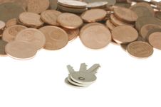 Bunch Of Keys In Front Of Pile Of Cents Royalty Free Stock Photos