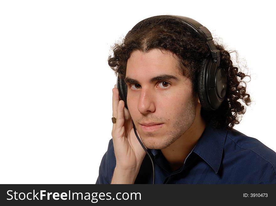 Young man listening to headphones, isolated on white. Young man listening to headphones, isolated on white