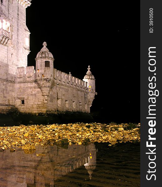 Detail from belem tower and reflection in water by night