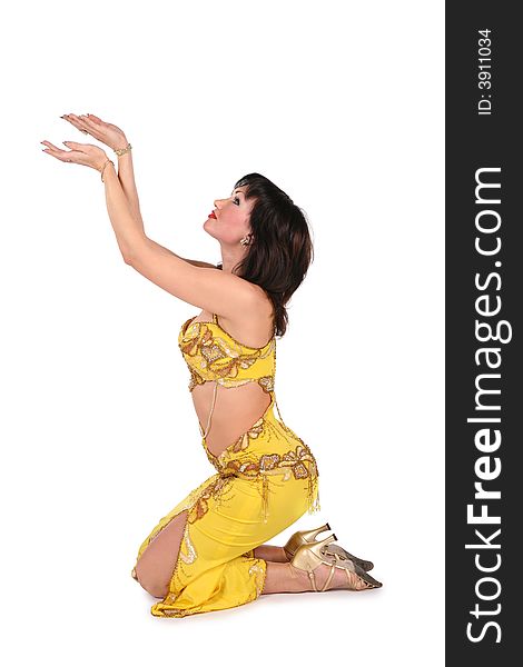 Yellow bellydancer on knees on white