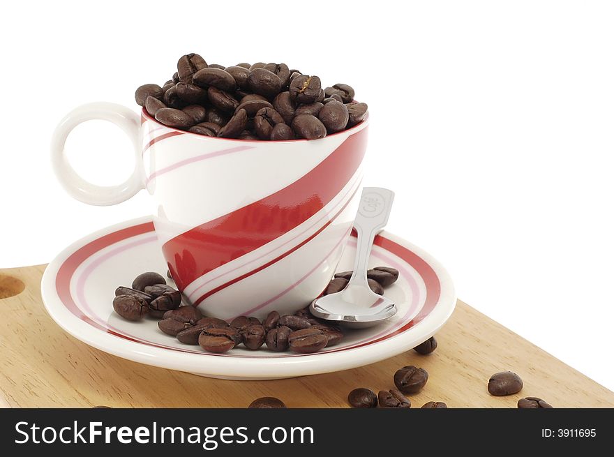 Fresh roasted coffee beans in a colorful cup. Fresh roasted coffee beans in a colorful cup.