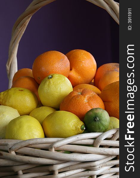 A basket of lemon, limes, and oranges. A basket of lemon, limes, and oranges