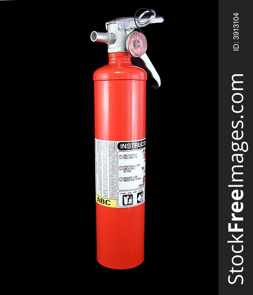 A red fire extinguisher against a black background.