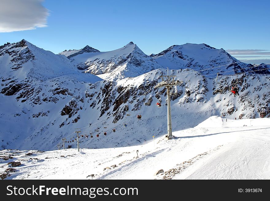 Ski Chair Lift Between High Mountains