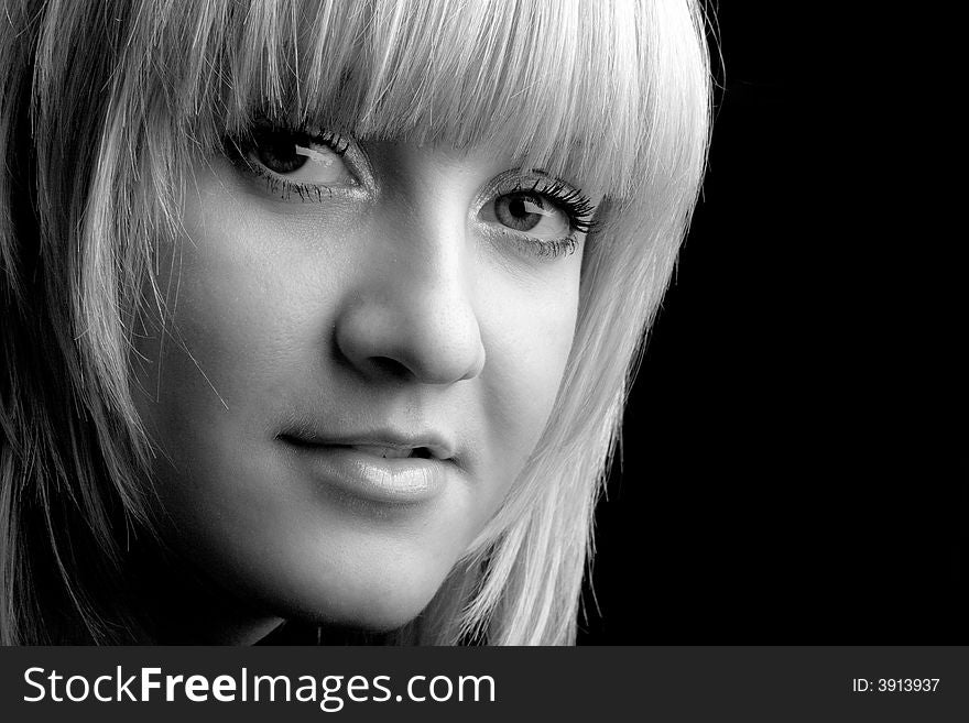 Studio portrait of a beatiful blond girl on black background. Studio portrait of a beatiful blond girl on black background