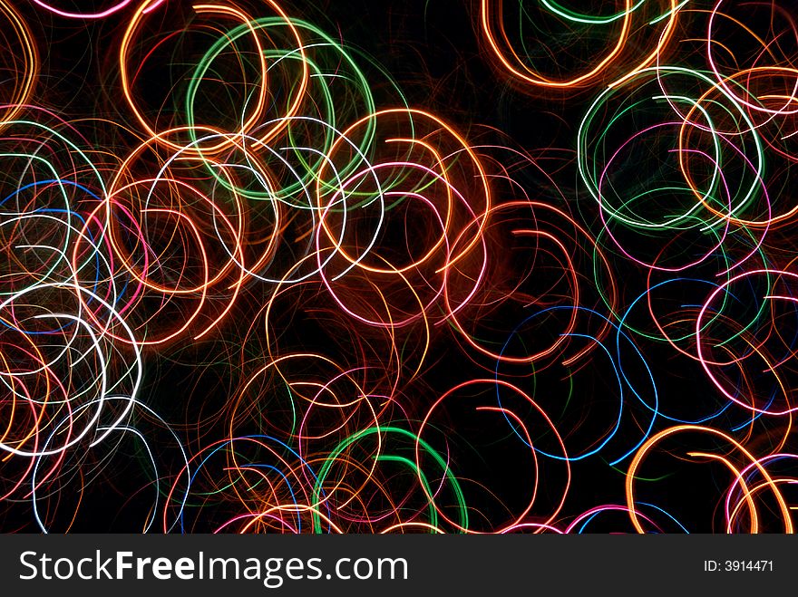 Multicolor circular abstract light tracks against black background. Multicolor circular abstract light tracks against black background