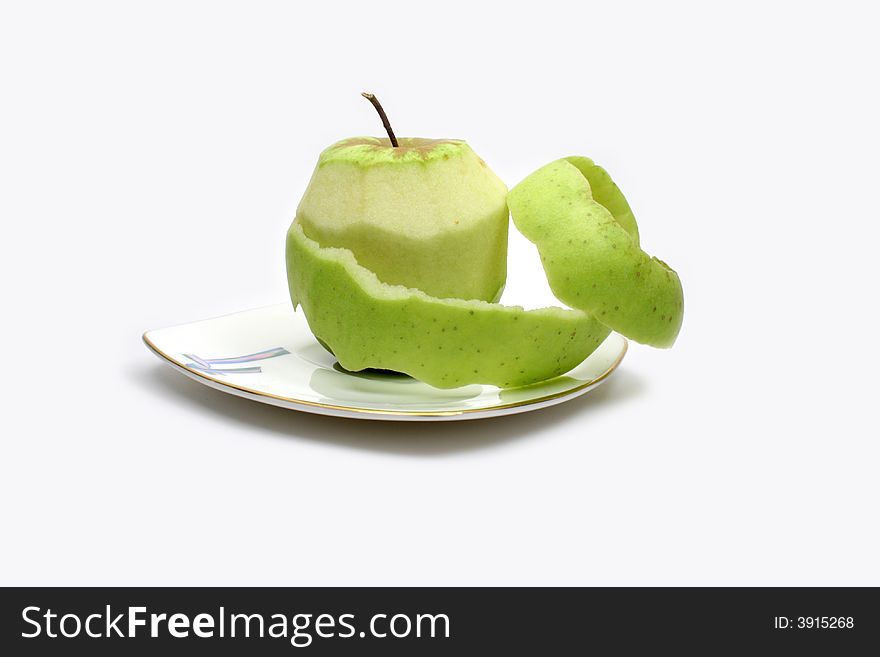 Fresh green apple on white plate on white background