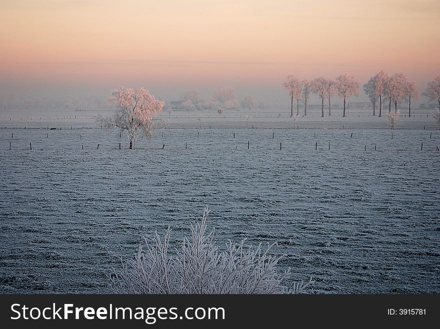 Sunrise over a winter landscape in the north of Belgium (region Antwerp)