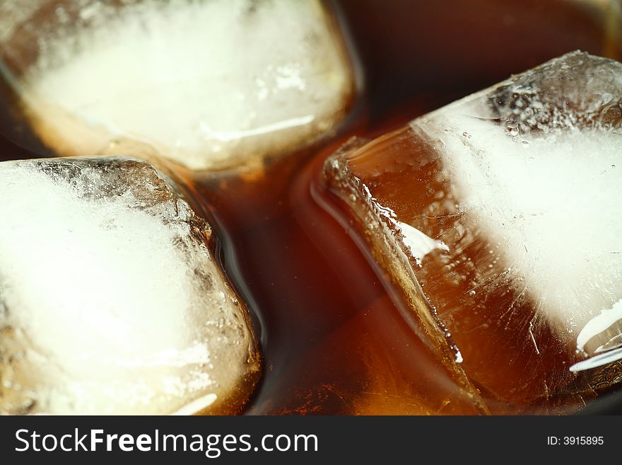 Ice cubes soaked in cold whisky drink