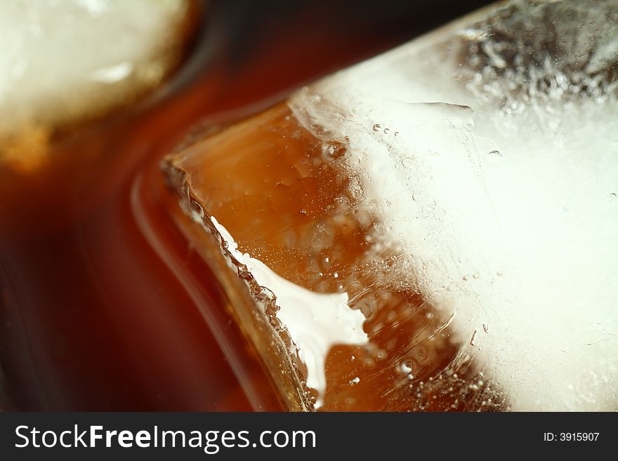 Ice cubes soaked in cold whisky drink
