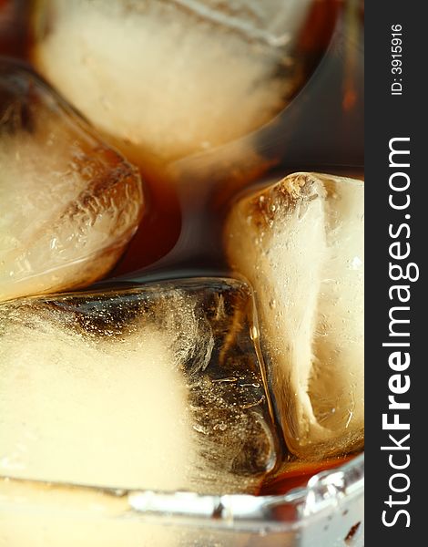 Ice cubes soaked in cold whisky drink